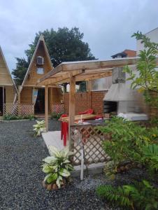 a barbecue in the backyard of a house at Chalé solmar in Penha