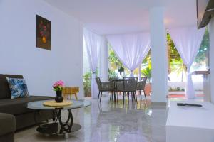 a living room with a couch and a table at Harmonia - Sunbeha resort, Juan Dolio in Juan Dolio