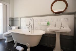 a bathroom with a tub and a sink at Burnhopeside Hall in Lanchester