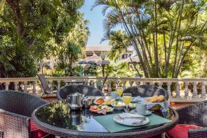 a table with food and drinks on a patio at Paramanta Lifestyle Hotel in Asunción
