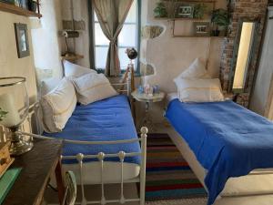 a bedroom with two beds and a window at Villa Ochre - Rustic Retreat in Tsilivi +102 photos