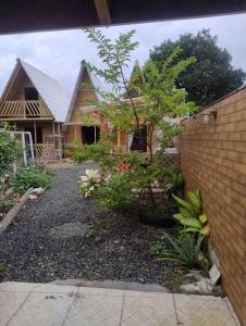 a house with a garden in front of it at Chalé solmar in Penha