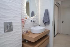 a bathroom with a sink and a mirror at Casa John Kos Apartment in Zipárion +60 photos