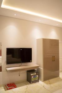 a living room with a flat screen tv on a wall at The Edition Signature in Bahawalpur +22 photos