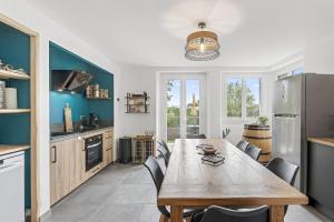 a kitchen with a wooden table and chairs at Les Gîtes Du Saro in Chabestan