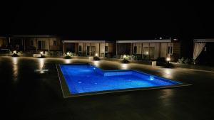a swimming pool in front of a building at night at Mobile Home Camp Dalmata Orebić in Orebić