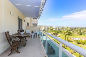 a balcony with a table and a view of the ocean at Los Juncos HomeStay by Turismar in La Pineda