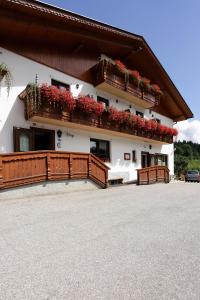 a building with flowers on the side of it at Hotel Al Sole in Tarvisio +18 photos