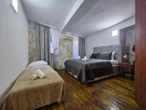 a bedroom with two beds with towels on them at Casa Di Kotor in Kotor