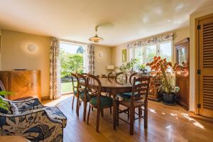 a dining room with a table and chairs at Lanes End by Keepers Cottages in Woodchurch