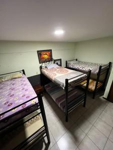 a room with two bunk beds in it at Ibiza Hostel Suites in Santa Cruz de la Sierra +2 photos