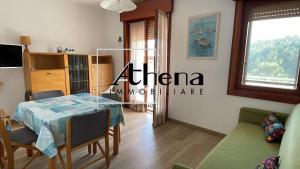 a room with a table and chairs and a window at Sole in Grado
