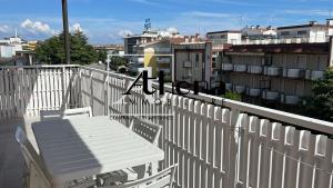 a white table and chairs on a balcony at Sole in Grado