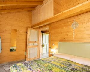 a bedroom with wooden walls and a bed in a room at Il Campo di Nonno Giò in Spoleto +87 photos