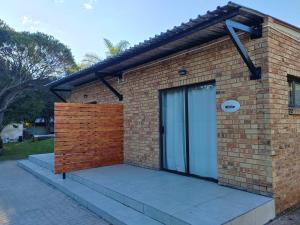 a brick house with a large glass door at Hillsview, Roodepoort in Roodepoort