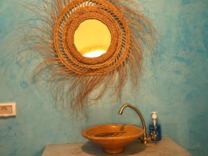a bathroom with a wooden sink and a mirror at TenasBook Houch Yassmine in Erriadh +36 photos