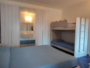 a bedroom with two bunk beds and a mirror at Casa Osvaldo in Marciana