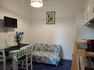 a living room with a chair and a table at Casa Osvaldo in Marciana
