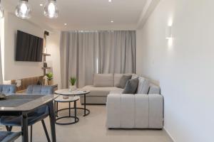 a living room with a couch and a table at Casa John Kos Apartment in Zipárion