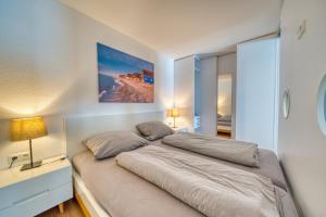 a bedroom with a large bed with two pillows at Ferienpark - Haus H, App 0H1107 - Apartment Baltic Panorama in Heiligenhafen