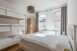 a bedroom with two bunk beds and two windows at Ferienwohnung Schlossperle in Klütz