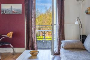 a living room with a couch and a balcony at Ferienwohnung Schlossperle in Klütz +6 photos
