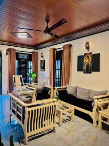 a living room with a couch and chairs at LEAFORA Cottage in Galle