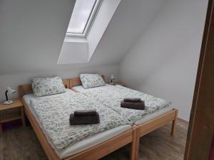 a bedroom with a bed with two towels on it at Ubytování Blažej in Týnec