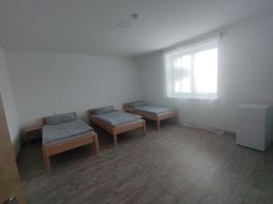 an empty room with two benches and a window at Ubytování Blažej in Týnec