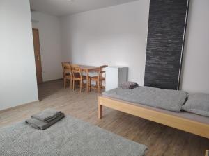 a room with two beds and a table and chairs at Ubytování Blažej in Týnec