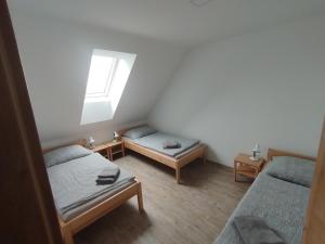 a room with two twin beds and a window at Ubytování Blažej in Týnec +5 photos