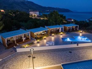 an aerial view of a villa with a swimming pool at night at Mobile Home Camp Dalmata Orebić in Orebić