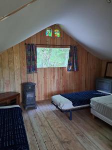 a bedroom with a bed and a wood stove at Camping Terre Rouge in Villecomtal