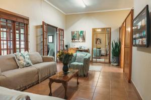 a living room with a couch and a table at Home on a Hill Accommodation in Tzaneen
