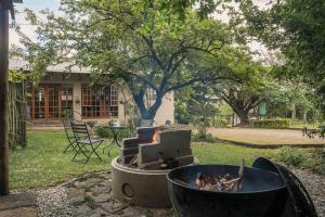 a fire pit in the yard of a house at Home on a Hill Accommodation in Tzaneen