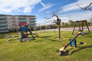 a group of swings in a park at Los Juncos HomeStay by Turismar in La Pineda