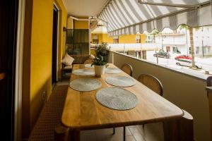 a row of tables in a room with a balcony at Liu' casa vacanze in Ortona +15 photos