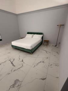 a bedroom with a bed and a marble floor at Vulcano Rooms 4 in Catania
