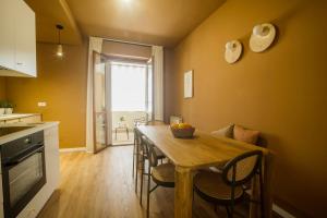 a kitchen with a wooden table with chairs and a dining room at Liu' casa vacanze in Ortona