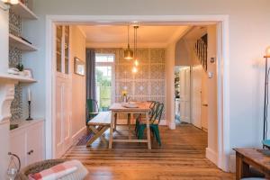 a dining room with a wooden table and chairs at Whispering Waves by Keepers Cottages in Hythe +20 photos