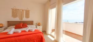 a bedroom with a bed and a large window at Duplex Ancla in L'Ametlla de Mar
