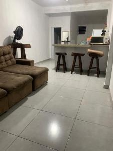 a living room with a couch and a table at Kitnet Céu e mar Saquarema in Saquarema