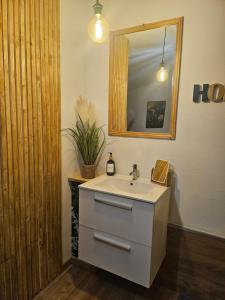a bathroom with a sink and a mirror at Chambre Mare a Mare in Porto-Vecchio