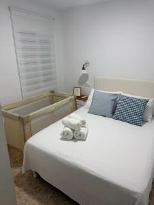 a bedroom with a bed with towels on it at Alma azul in Puerto de Mazarrón