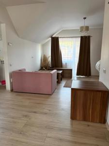 a living room with a couch and a table at Vanessa Home in Floreşti
