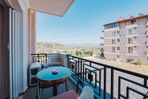 a balcony with a table and a view of a building at Hotel Almar in Sarandë