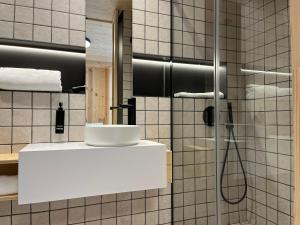 a bathroom with a shower and a sink at VTZ Minimal Suites in Zaragoza +10 photos