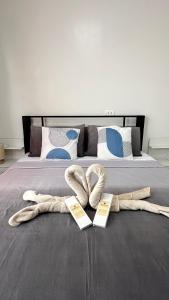 a bed with two pairs of towels on it at Azure Edge in Dauis +54 photos