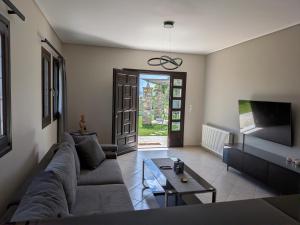 a living room with a couch and a table at Homezie AGRIA in Agria