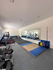 a gym with pilates equipment and people in the background at Azure Edge in Dauis
